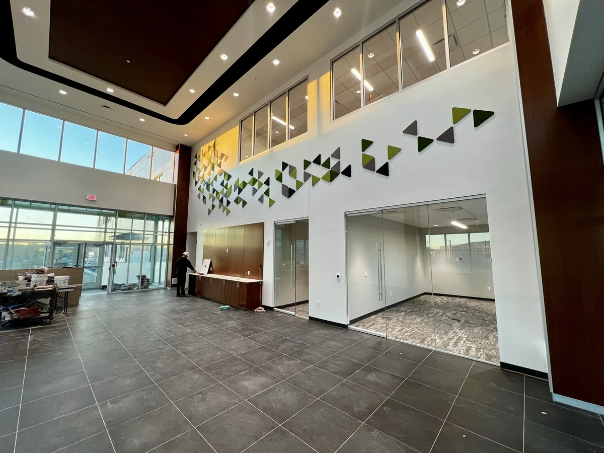 Two-story lobby atrium with aluminum curtainwall glazing and interior glass