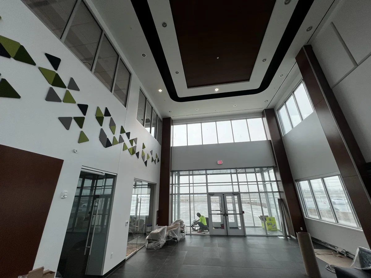 Glazed main entrance with aluminum doors and window wall under construction