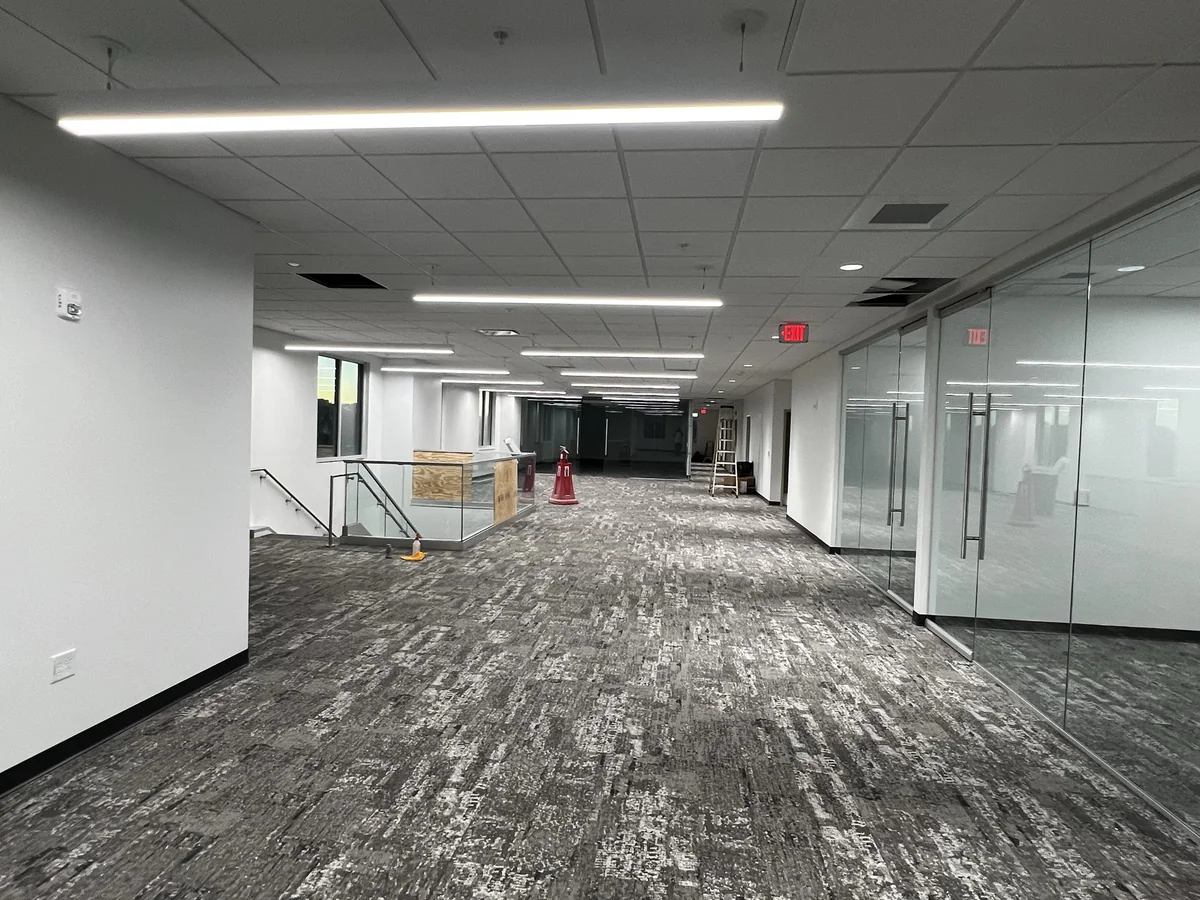 Interior office corridor with frameless glass partition walls