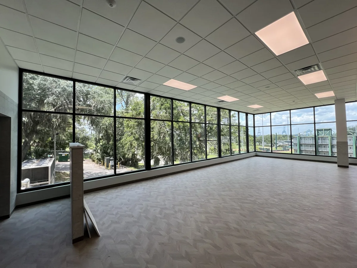 Corner room enclosed by a full-height aluminum framed window wall